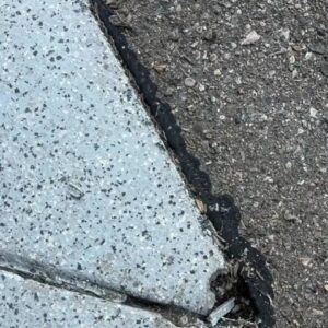 Old broken front lip of old epoxy flooring - Amber Dr Farmington Hills MI